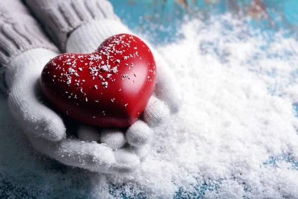 Hands in mittens with decorative heart — Stock Photo, Image