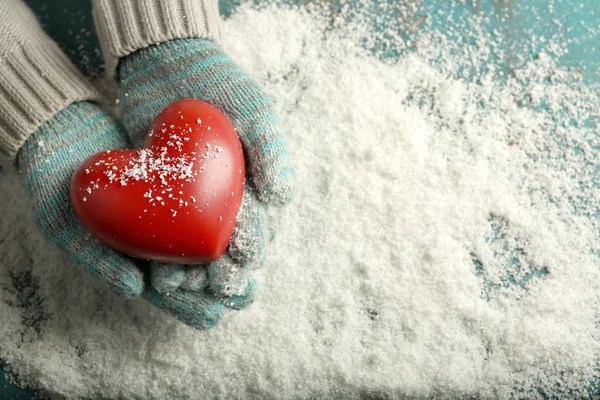 Hands in mittens with decorative heart — Stock Photo, Image