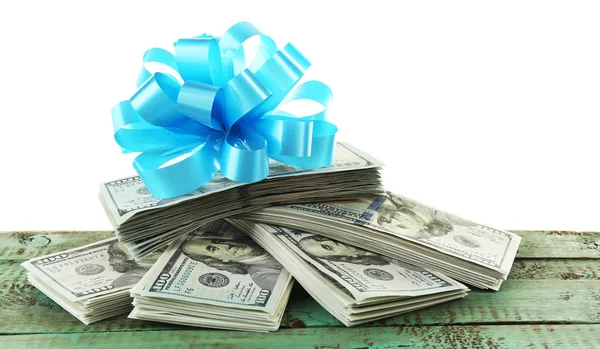 Pile of dollars with bow as gift — Stock Photo, Image