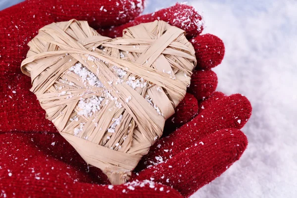 Hands in mittens with decorative heart — Stock Photo, Image