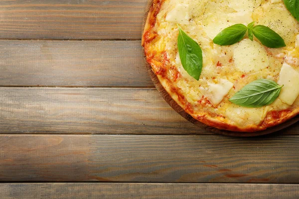Tasty pizza decorated with basil — Stock Photo, Image