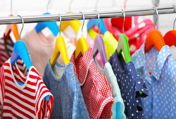 Clothes for kids on hangers — Stock Photo, Image