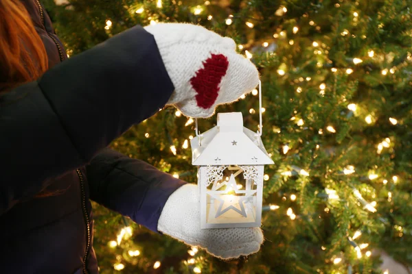 Female hands holding white lantern