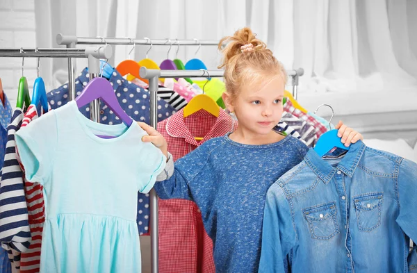 Little girl trying on clothes — Stock Photo, Image