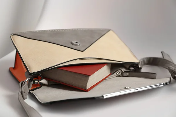 Fashion female handbag with book — Stock Photo, Image