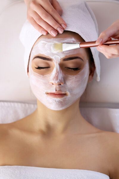 Young woman with facial mask