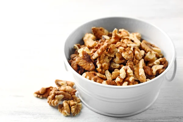 Walnut kernels in the metal bucket — Stock Photo, Image