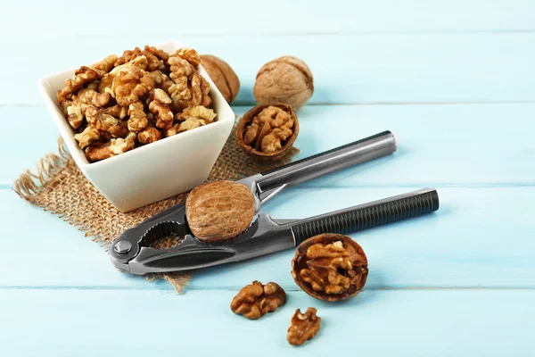 Walnuts in the bowl and nutcracker — Stock Photo, Image