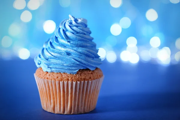 Cupcake with blue cream icing — Stock Photo, Image