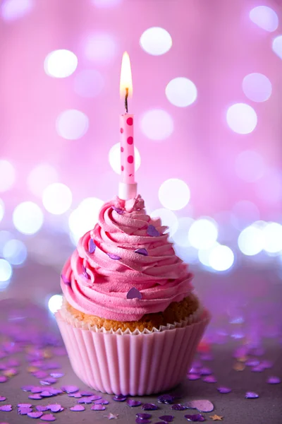 Cupcake con glaseado de crema rosa y vela —  Fotos de Stock