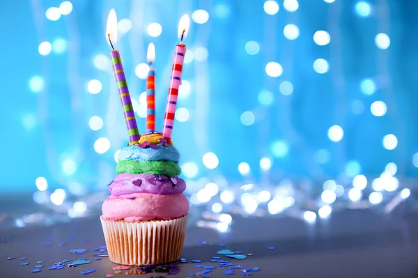 Cupcake with varicolored cream icing — Stock Photo, Image