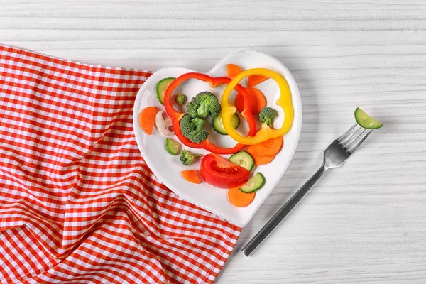 Vegetables on a plate in the form of heart — Stock Photo, Image