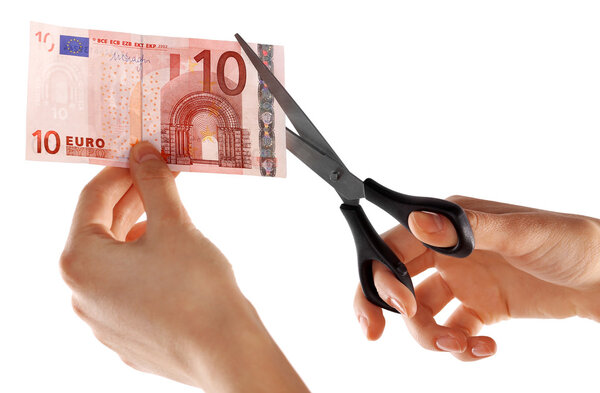Hands with scissors cutting Euro