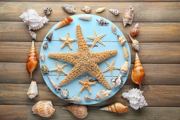Seashells on wooden table — Stock Photo, Image