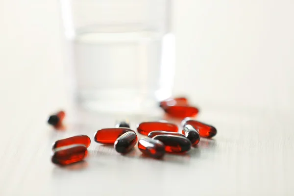 Capsules spilled from pill bottle — Stock Photo, Image