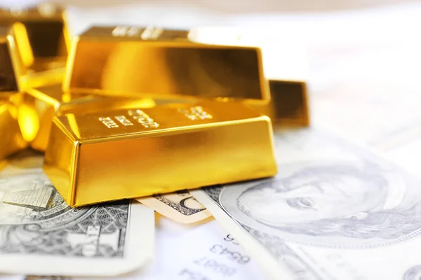 Gold bars on dollar banknotes — Stock Photo, Image