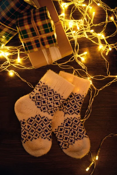 Warm woolen socks with Christmas gifts — Stock Photo, Image