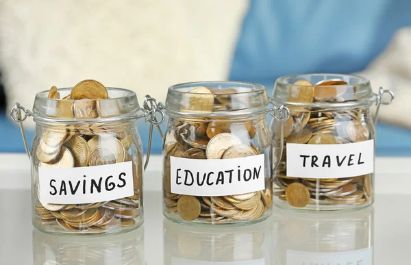 Glass jars with Ukrainian coins — Stock Photo, Image