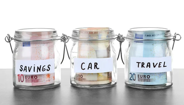 Jars for different needs full of banknotes — Stock Photo, Image