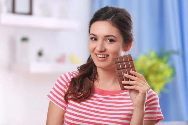 Young brunette with chocolate — Stock Photo, Image
