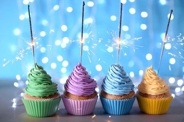 Varicolored cupcakes icing with sparklers — Stock Photo, Image
