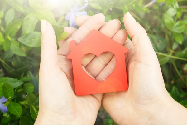 Female hands holding toy house — Stock Photo, Image