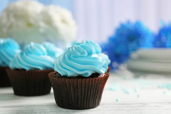 Chocolate cupcake with blue cream — Stock Photo, Image