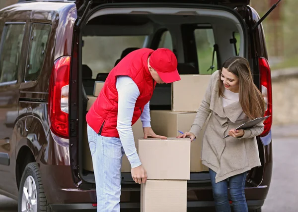 Delivery man and young woman Stock Picture