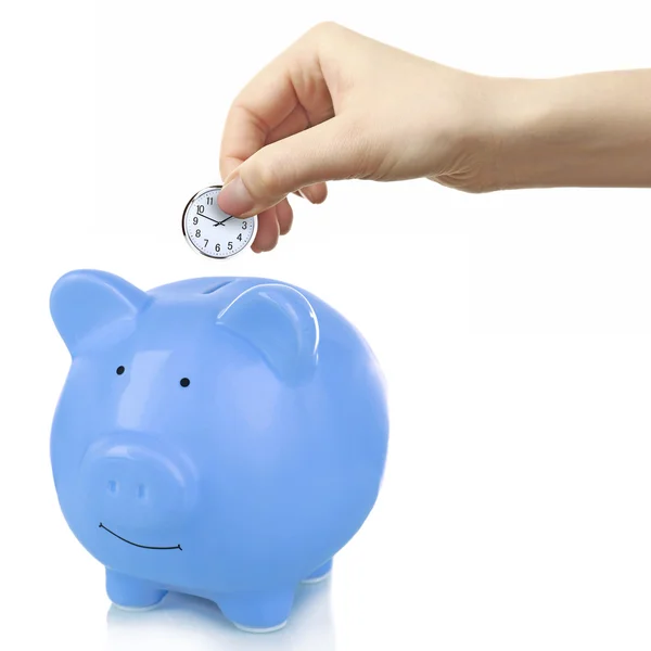 Hand depositing coin in piggy bank — Stock Photo, Image