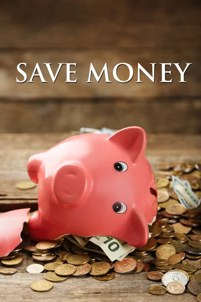 Broken piggy bank with cash and coins — Stock Photo, Image