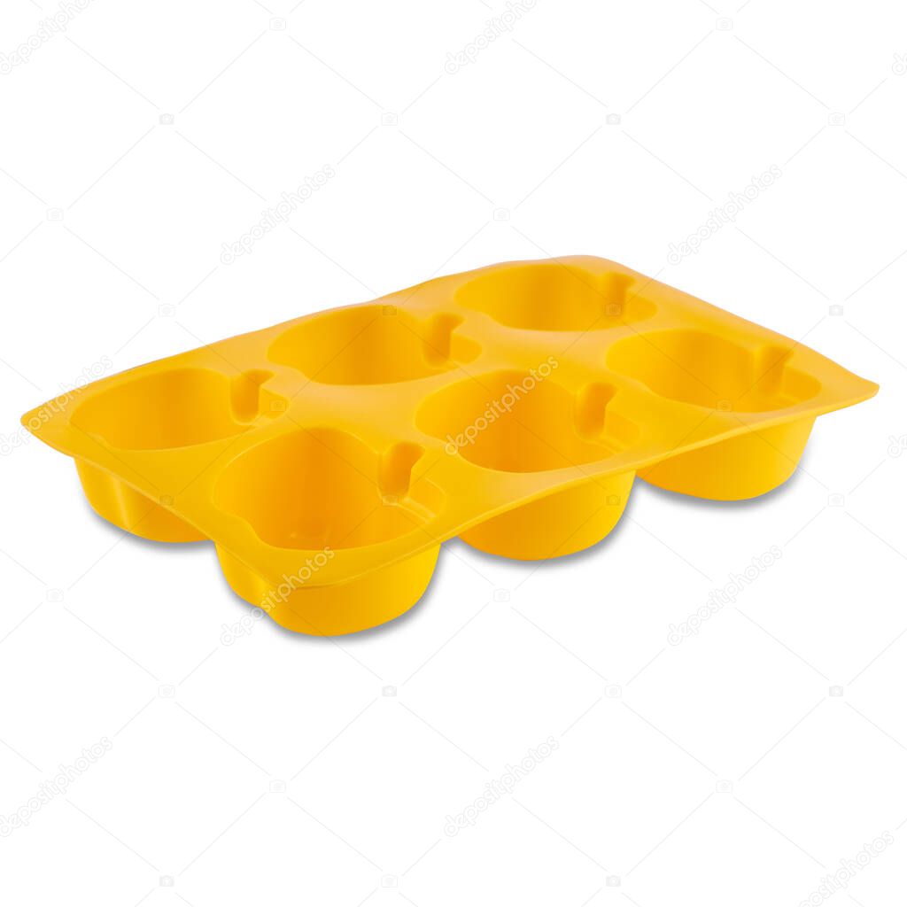 Yellow silicone muffin form isolated on white background. Cake cup, silicone mold, bakeware. 