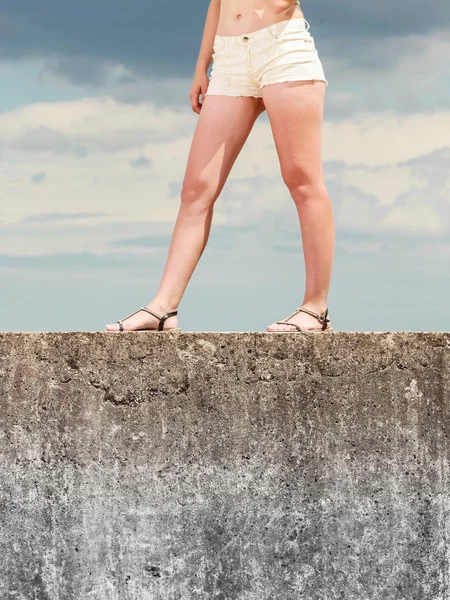 Woman legs in summer shorts against sky — Stock Photo, Image