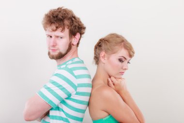 Young couple after quarrel offended back to back clipart