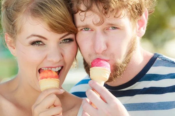 young couple eating ice cream outdoor