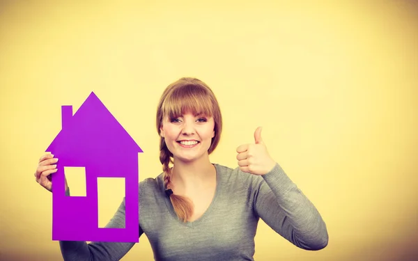 Mujer feliz sosteniendo modelo de casa . — Foto de Stock