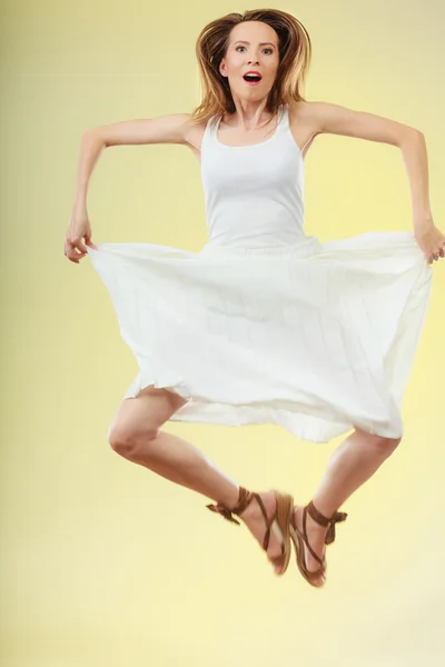 Женщина в белом платье прыгает летом — стоковое фото