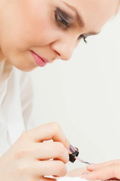 Female beautician making nails. Stock Photo