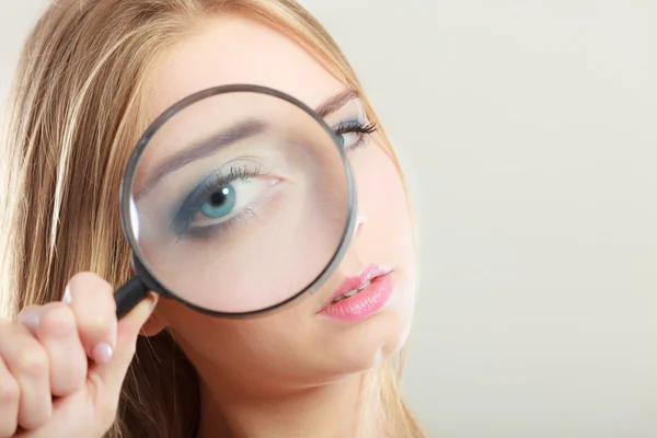 Girl holding on eye magnifying glass loupe Stock Photo