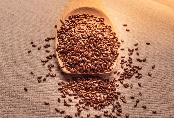 Flax seeds in wooden spoon — Stock Photo, Image