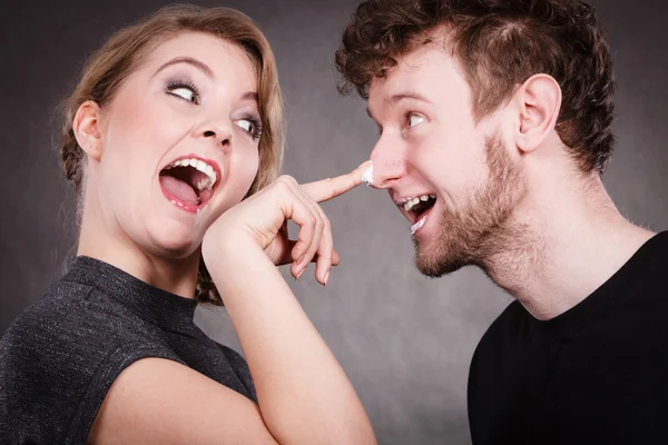 Young couple fooling with cream — Stock Photo, Image