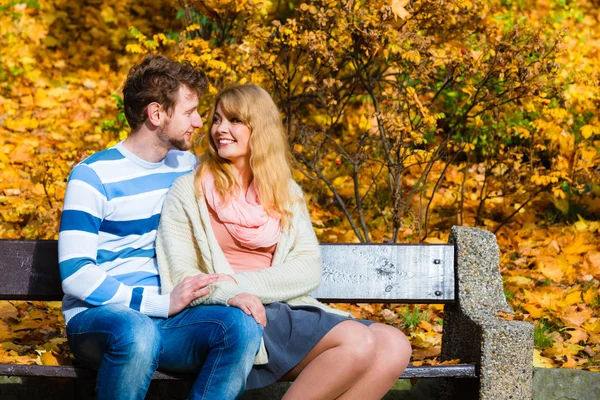 Coppia di innamorati nel parco autunnale sulla panchina — Foto Stock