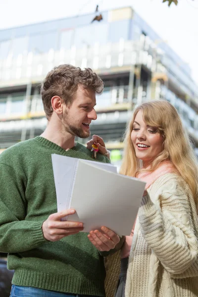 Par med blueprint projektet nycklar på byggarbetsplats — Stockfoto