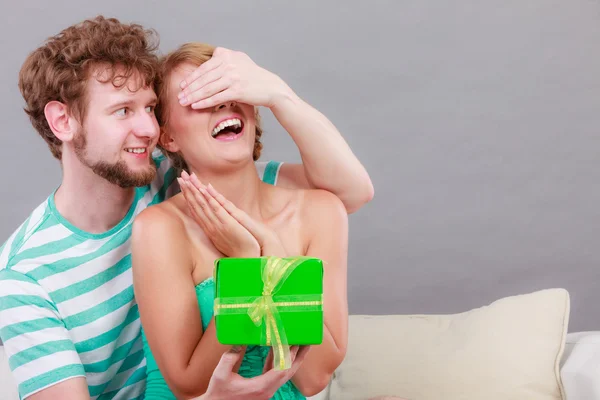 Young man giving woman gift box Royalty Free Stock Images