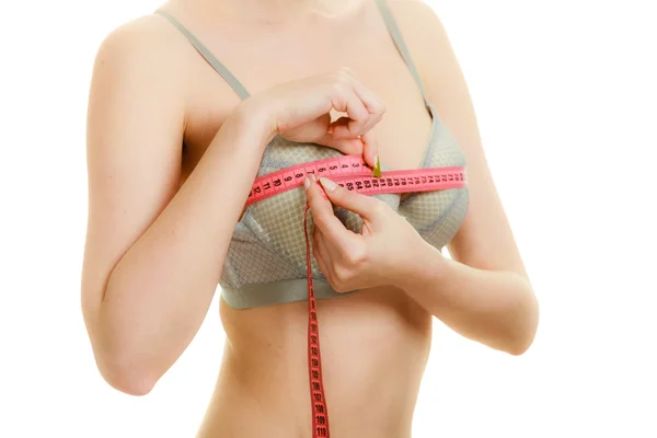 Woman in bra lingerie measuring her chest breasts. — Stock Photo, Image