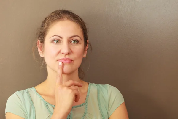 Thoughtful emotional woman in studio — Stock Photo, Image