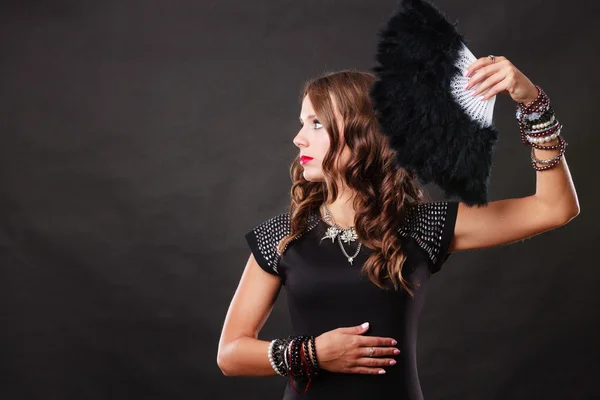 Beautiful brunette woman with black fan in hand — Stock Photo, Image