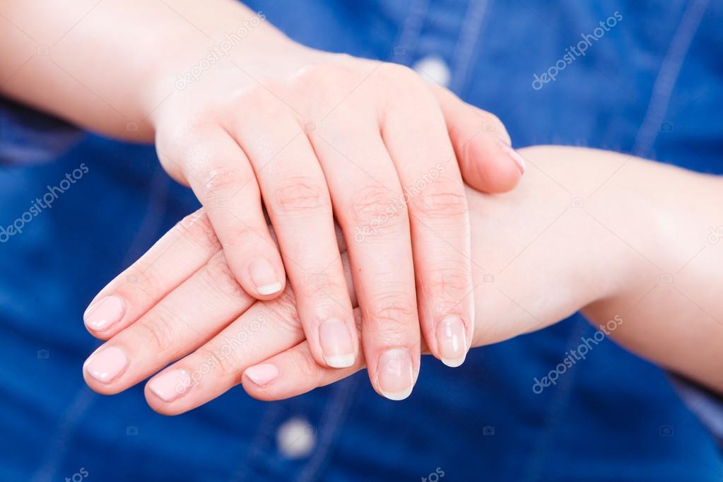 Woman presents hands nails.