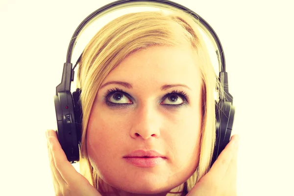 Blonde girl in big headphones. — Stock Photo, Image