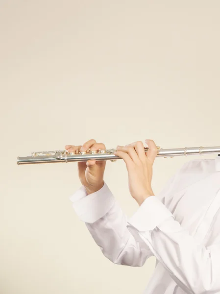 Flute music instrument in hands of flutist musician