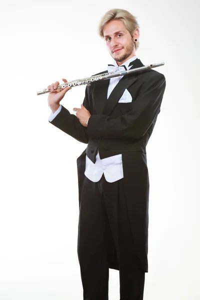 Male flutist wearing tailcoat holds flute — Stock Photo, Image